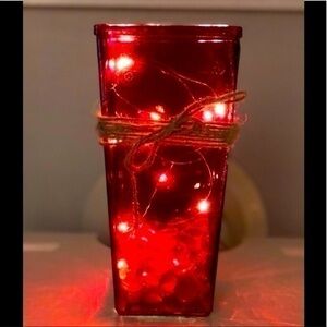 Red vase with lights and twine